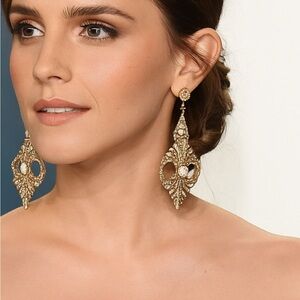 Pair of gold-toned chandelier earrings with crystal and cubic zirconia stones.